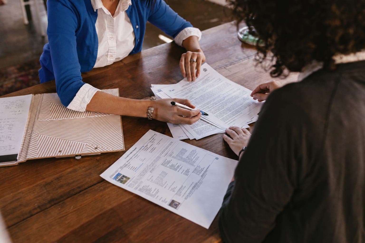 An agent reviewing a trucking insurance policy line by line with a client